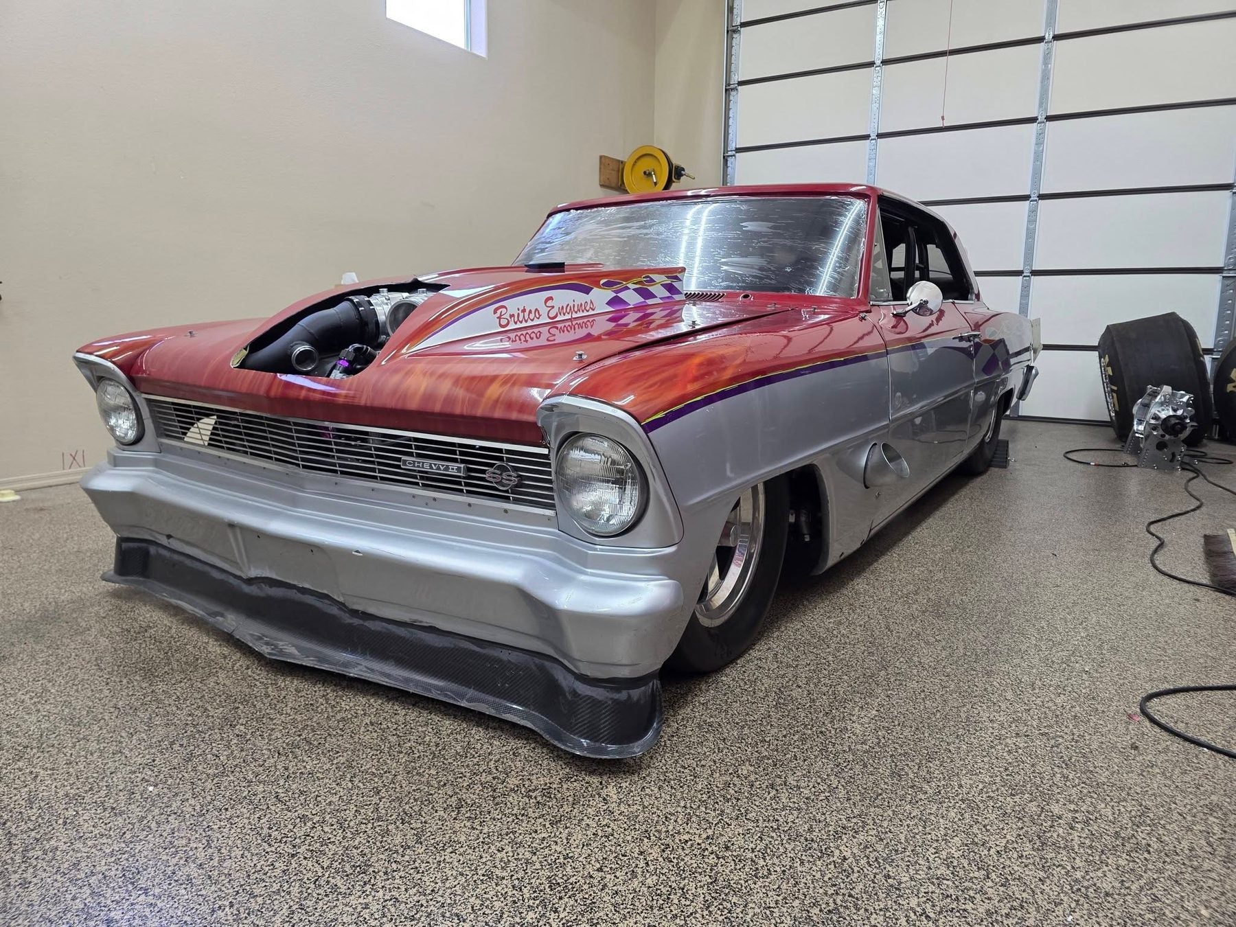 Custom flame-painted Nova SS in shop