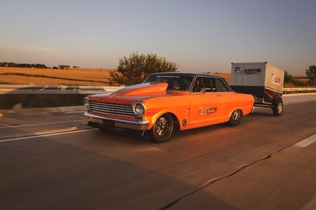 63 Nova towing enclosed trailer at golden hour